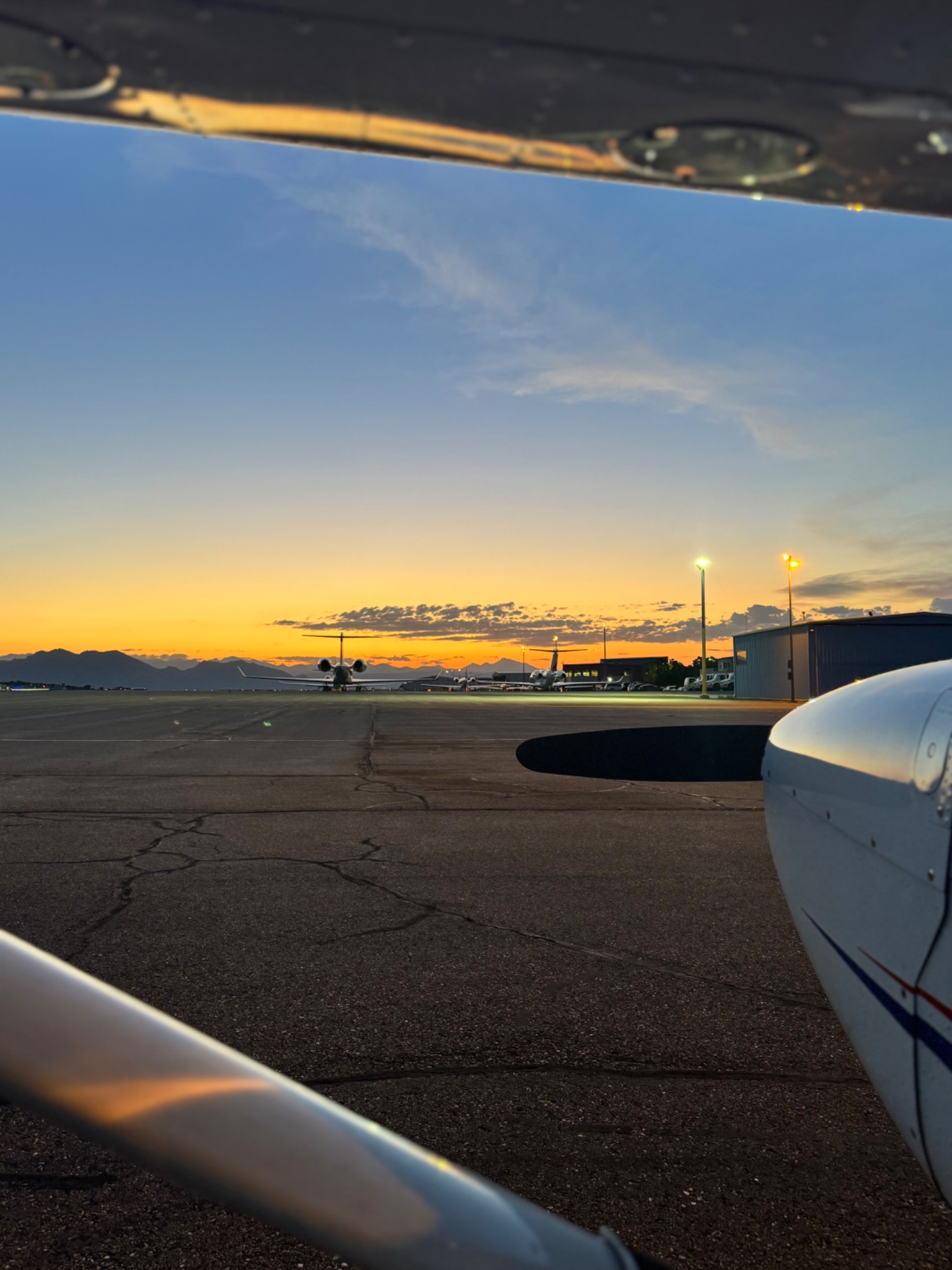 Sunset view from an aircraft on the airport ramp